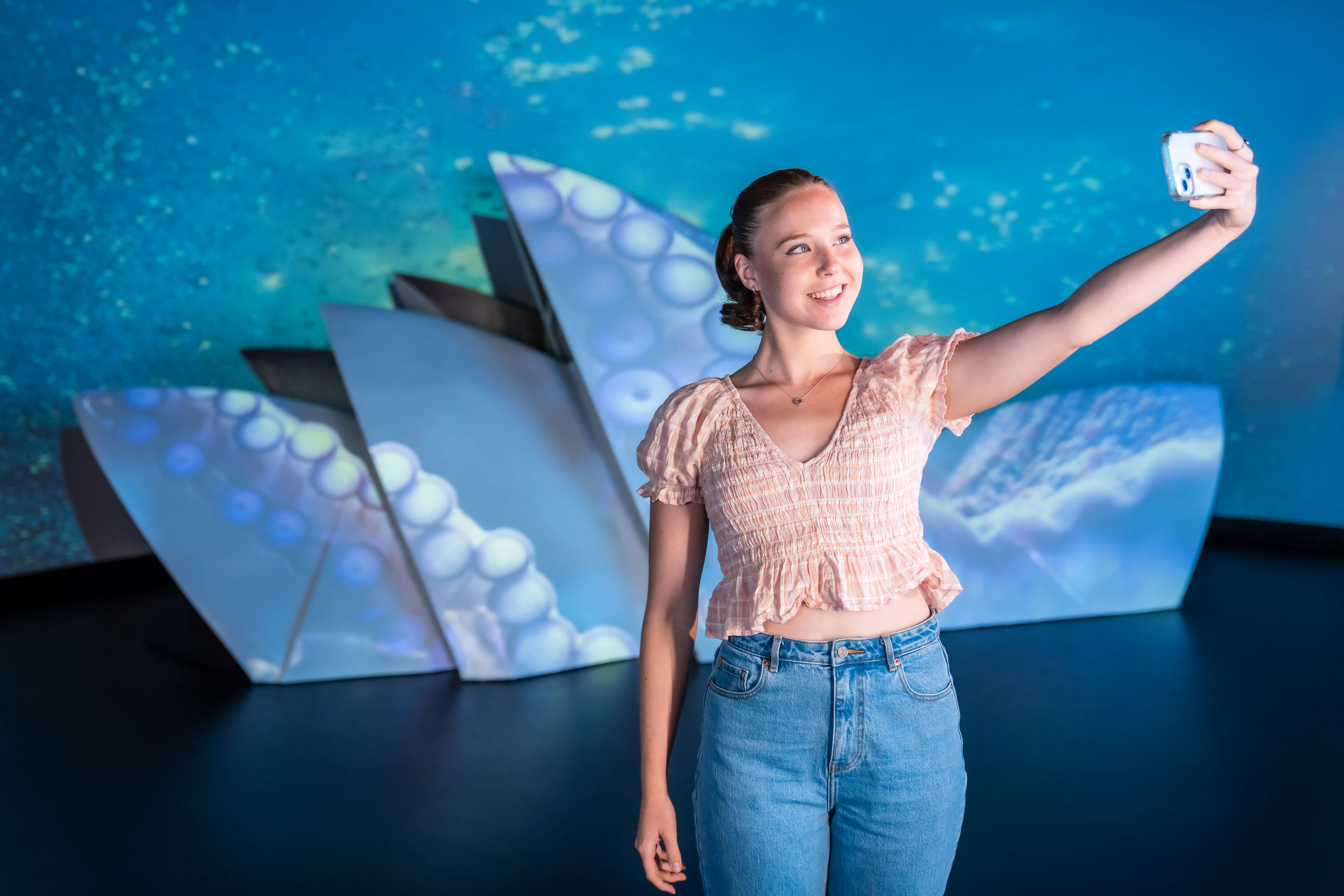 Guest posing with Sydney Opera House Model